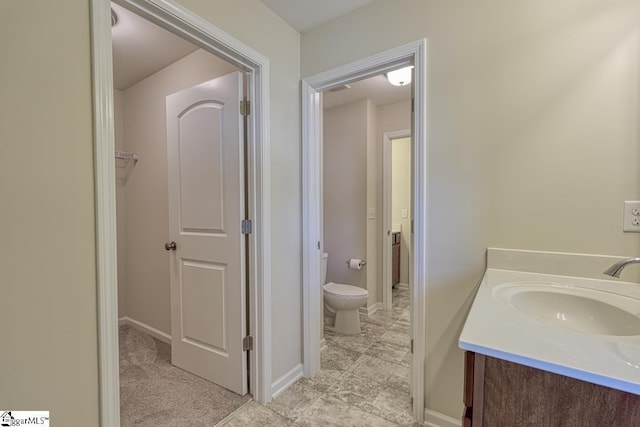 bathroom featuring vanity and toilet