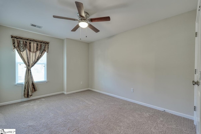 empty room with ceiling fan and carpet floors