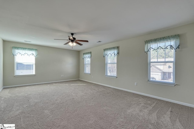 empty room with light colored carpet and ceiling fan