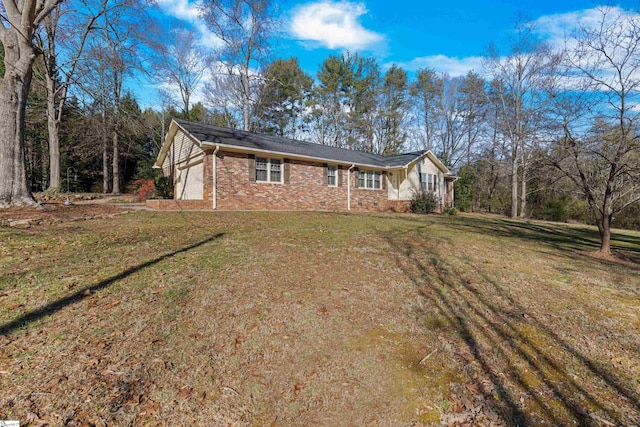 view of front of home with a garage and a front lawn