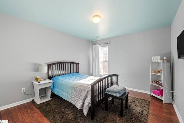 bedroom featuring dark hardwood / wood-style flooring