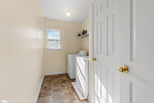 clothes washing area featuring separate washer and dryer