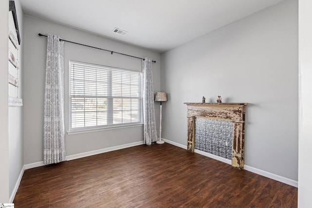 unfurnished living room with dark wood-type flooring