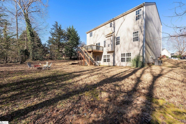 back of property with a yard, cooling unit, and a deck