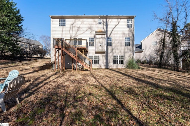 rear view of property featuring a yard and a deck