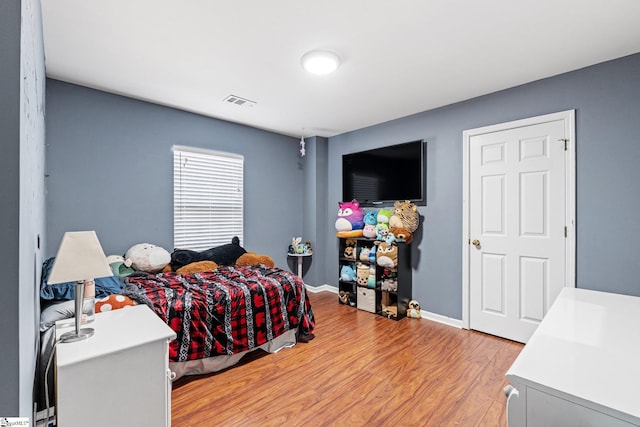 bedroom with light wood-type flooring