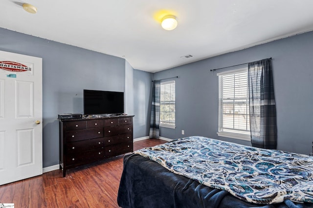 bedroom with dark hardwood / wood-style floors