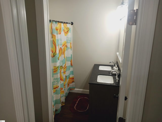 bathroom with walk in shower and vanity