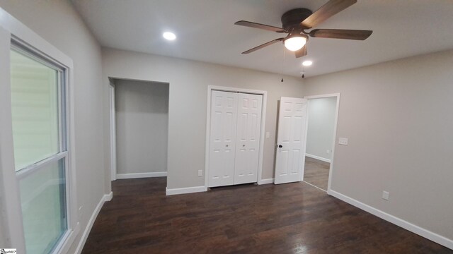 unfurnished bedroom featuring ceiling fan and dark hardwood / wood-style flooring