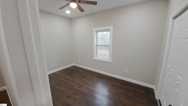 unfurnished room featuring ceiling fan and dark hardwood / wood-style floors