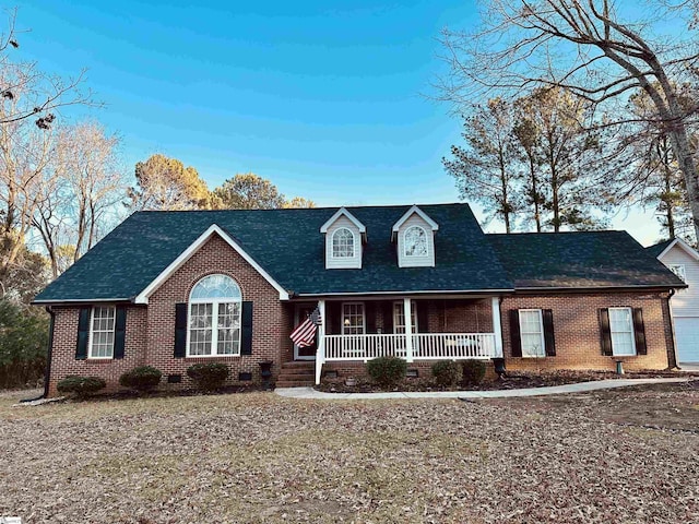 new england style home with a porch