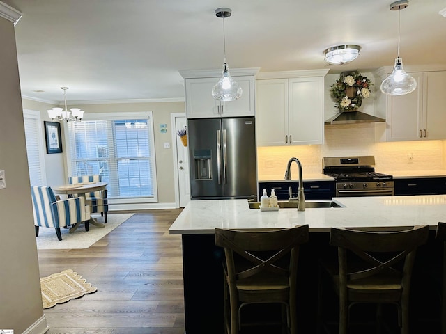 kitchen featuring a kitchen breakfast bar, light stone counters, stainless steel appliances, wall chimney range hood, and white cabinetry