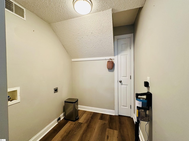 clothes washing area featuring hookup for a washing machine, a textured ceiling, dark wood-type flooring, and electric dryer hookup