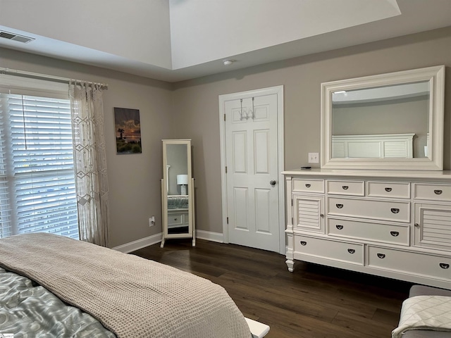 bedroom with dark hardwood / wood-style floors