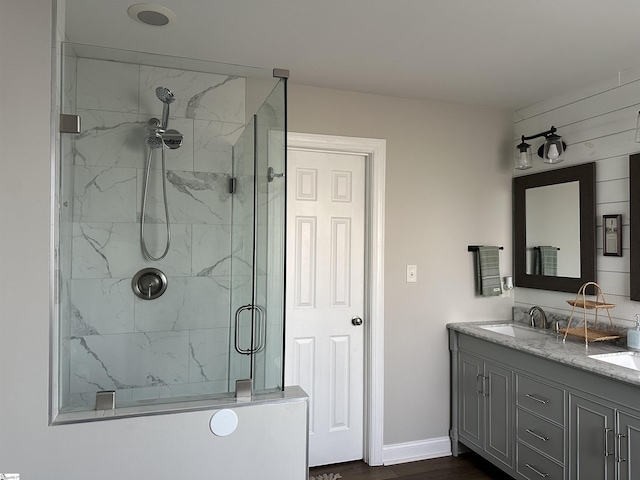 bathroom with a shower with shower door, wood-type flooring, and vanity