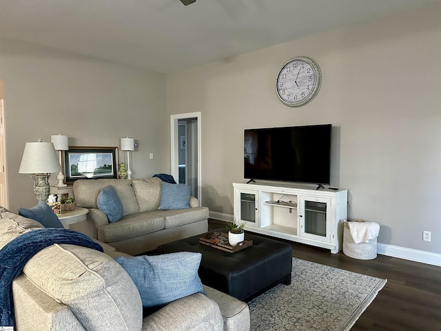 living room with dark hardwood / wood-style floors and ceiling fan