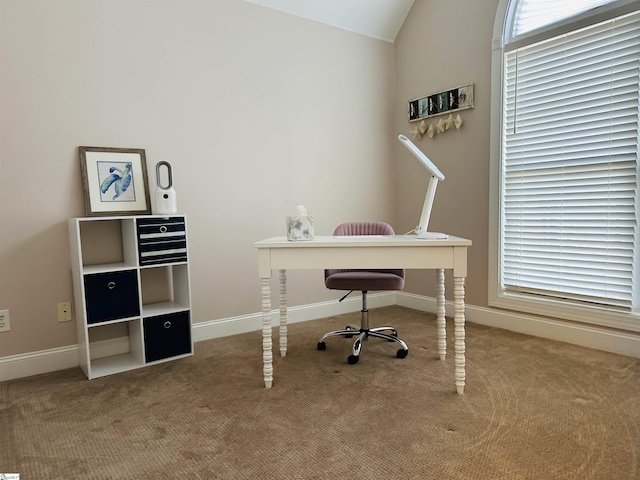 carpeted office space featuring vaulted ceiling