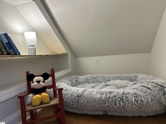 bedroom with dark hardwood / wood-style flooring and lofted ceiling