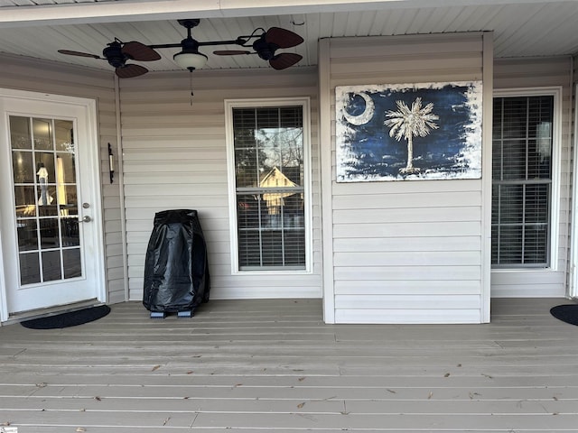 deck with ceiling fan and a porch