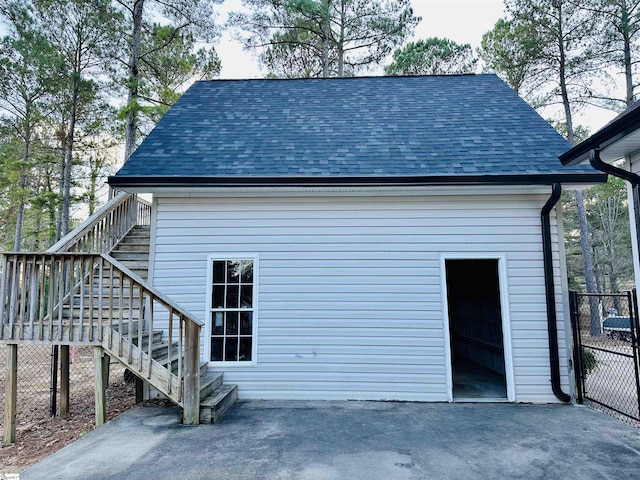 view of property exterior with a garage and an outdoor structure