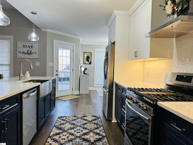 kitchen featuring dark hardwood / wood-style flooring, wall chimney exhaust hood, stainless steel appliances, decorative light fixtures, and white cabinetry