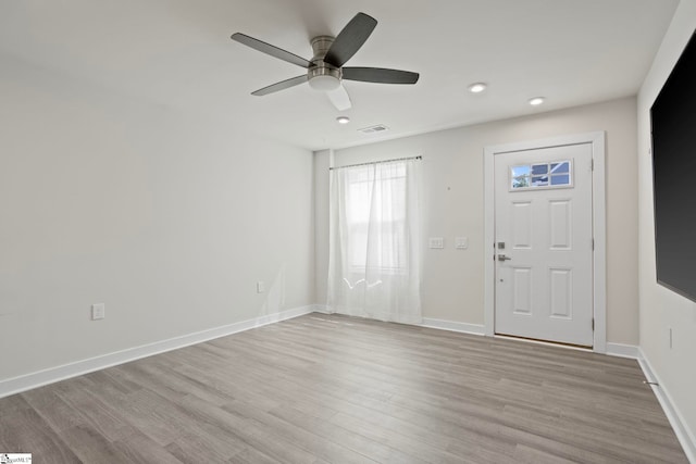 foyer entrance with ceiling fan and light hardwood / wood-style floors