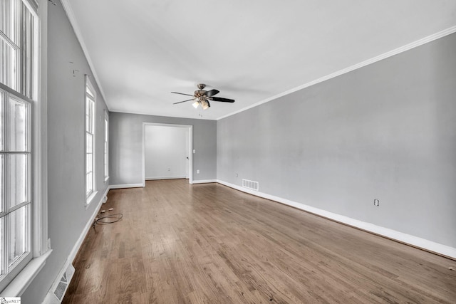 unfurnished room featuring ceiling fan, hardwood / wood-style floors, and crown molding