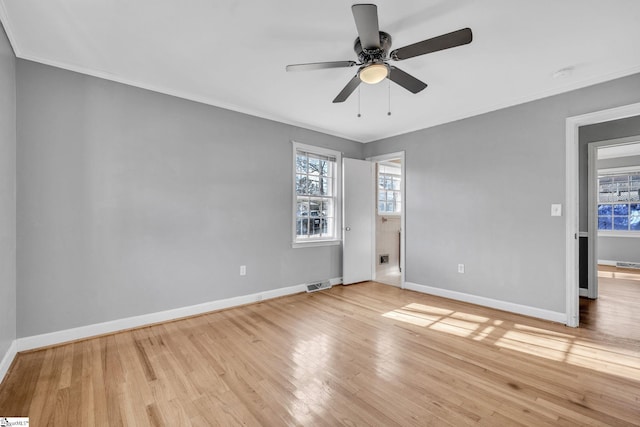 empty room featuring light hardwood / wood-style floors, ceiling fan, and crown molding