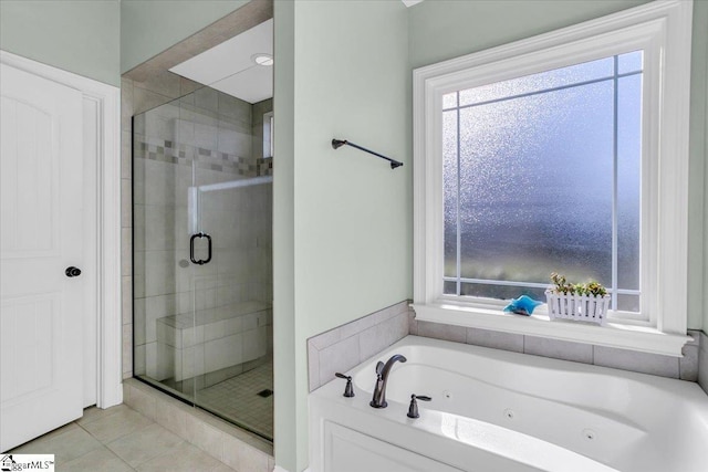 bathroom featuring tile patterned flooring and shower with separate bathtub