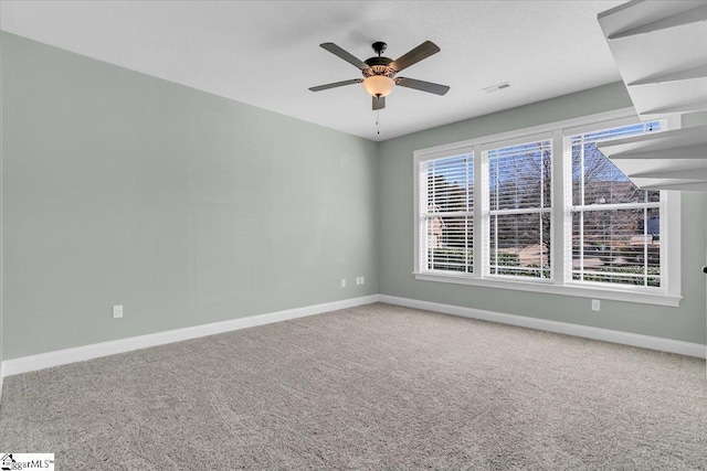 spare room with carpet and ceiling fan