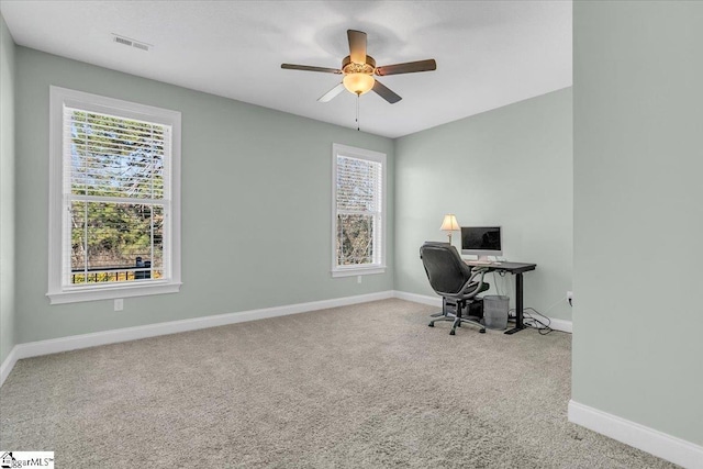 home office featuring light carpet and ceiling fan