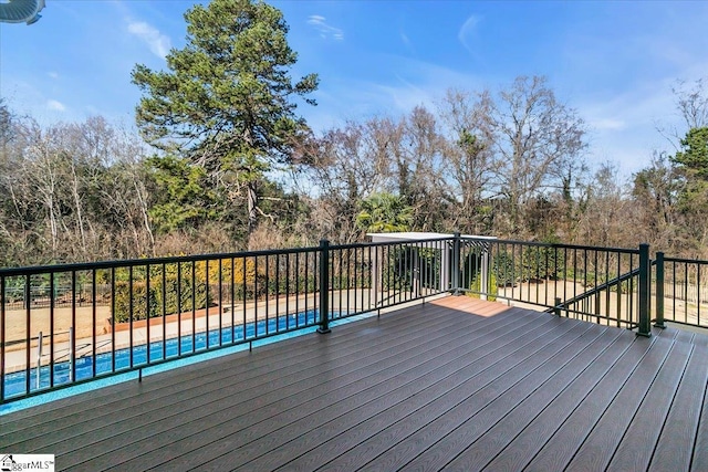 wooden deck featuring a fenced in pool