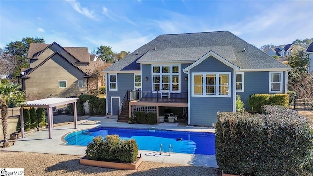 back of house with a pool side deck and a patio area