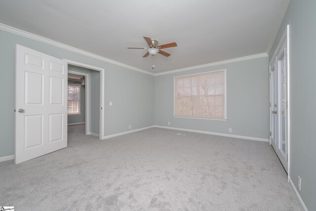 unfurnished bedroom with crown molding, ceiling fan, and light colored carpet