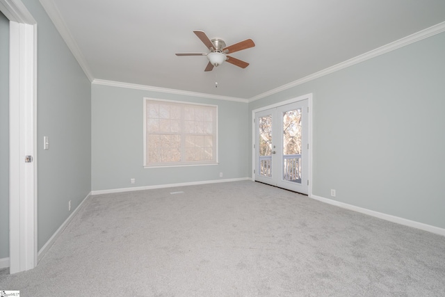 spare room featuring light colored carpet, ceiling fan, and crown molding