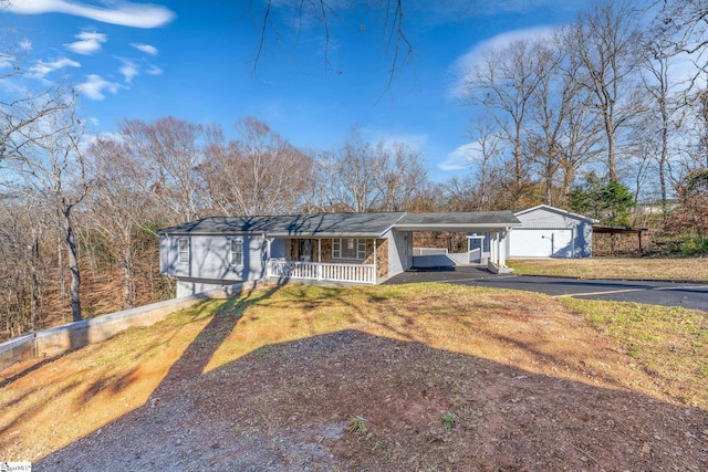 ranch-style home featuring a front yard, a porch, and a carport