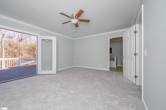 carpeted spare room featuring ceiling fan and ornamental molding