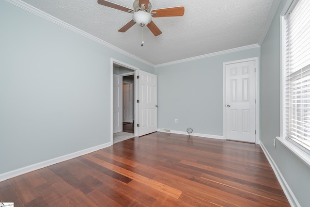 unfurnished bedroom featuring ceiling fan, dark hardwood / wood-style flooring, crown molding, and a textured ceiling