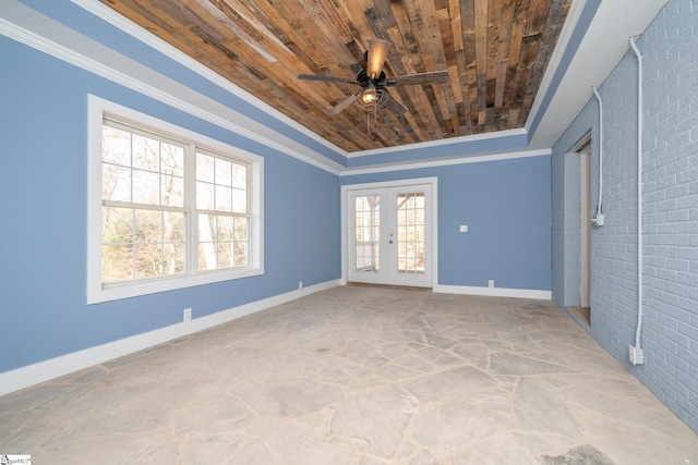 interior space featuring french doors, wooden ceiling, a raised ceiling, and ornamental molding