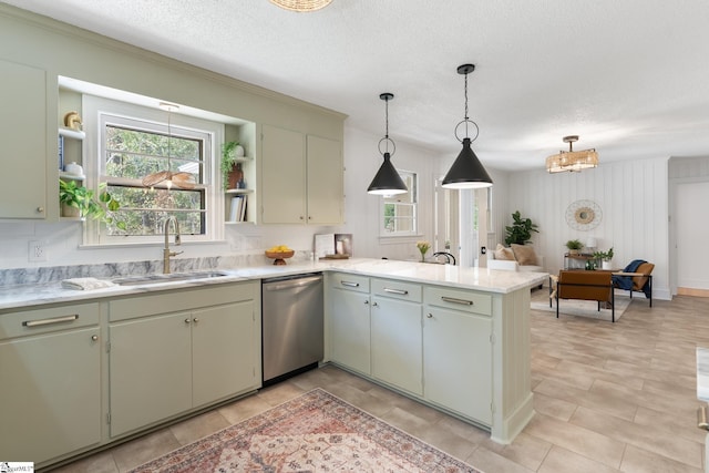 kitchen featuring dishwasher, sink, hanging light fixtures, kitchen peninsula, and a textured ceiling