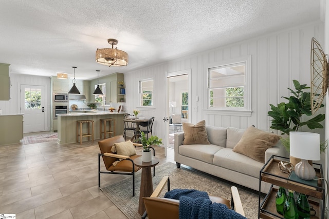 living room with light tile patterned flooring and a textured ceiling