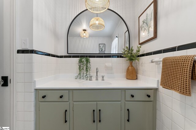 bathroom with vanity and tile walls