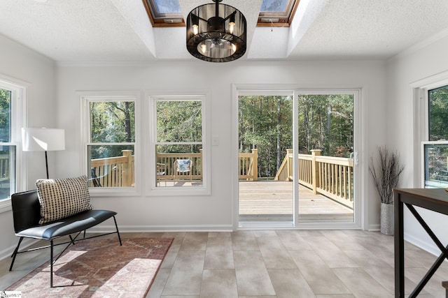 sunroom with a skylight and a notable chandelier