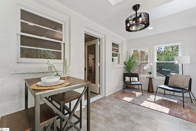 sunroom featuring a notable chandelier