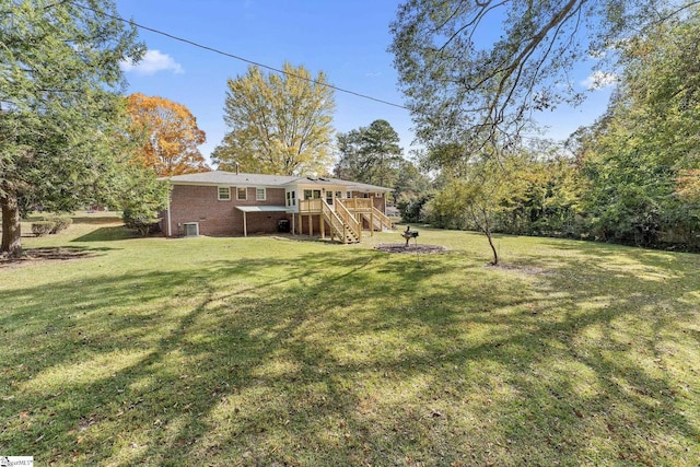 view of yard featuring a deck and central AC unit