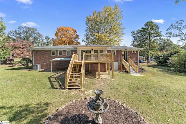 rear view of property featuring cooling unit, a lawn, and a deck