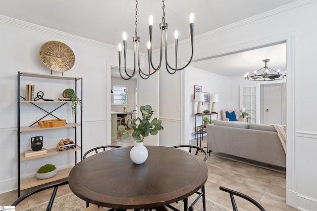 dining area with crown molding and an inviting chandelier