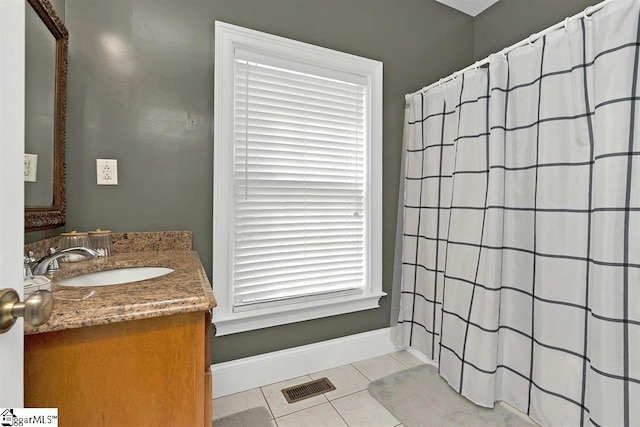 bathroom with tile patterned flooring and vanity