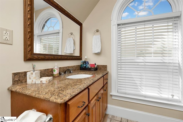 bathroom with vanity and vaulted ceiling