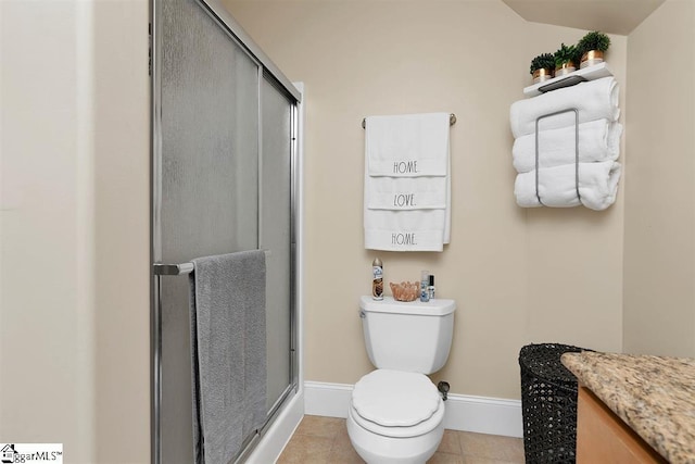 bathroom featuring toilet, tile patterned floors, and a shower with shower door